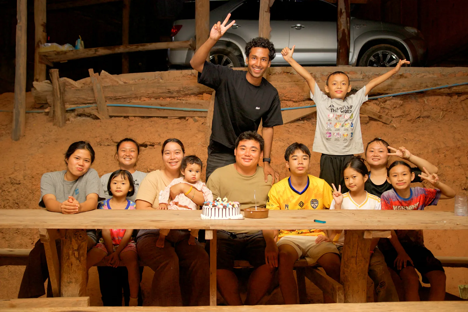 A guest posing with a village family