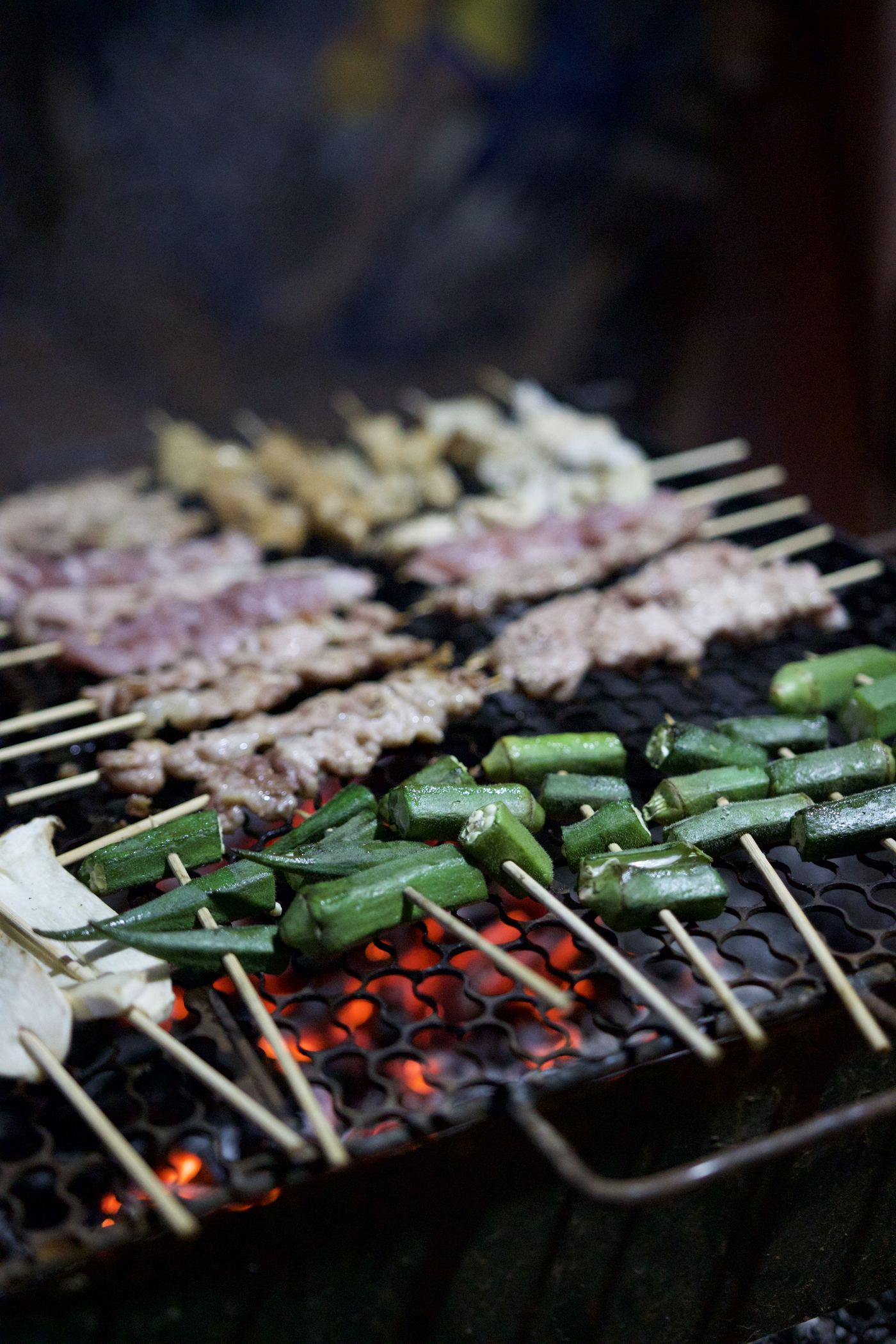 Skewers grilling over charcoal