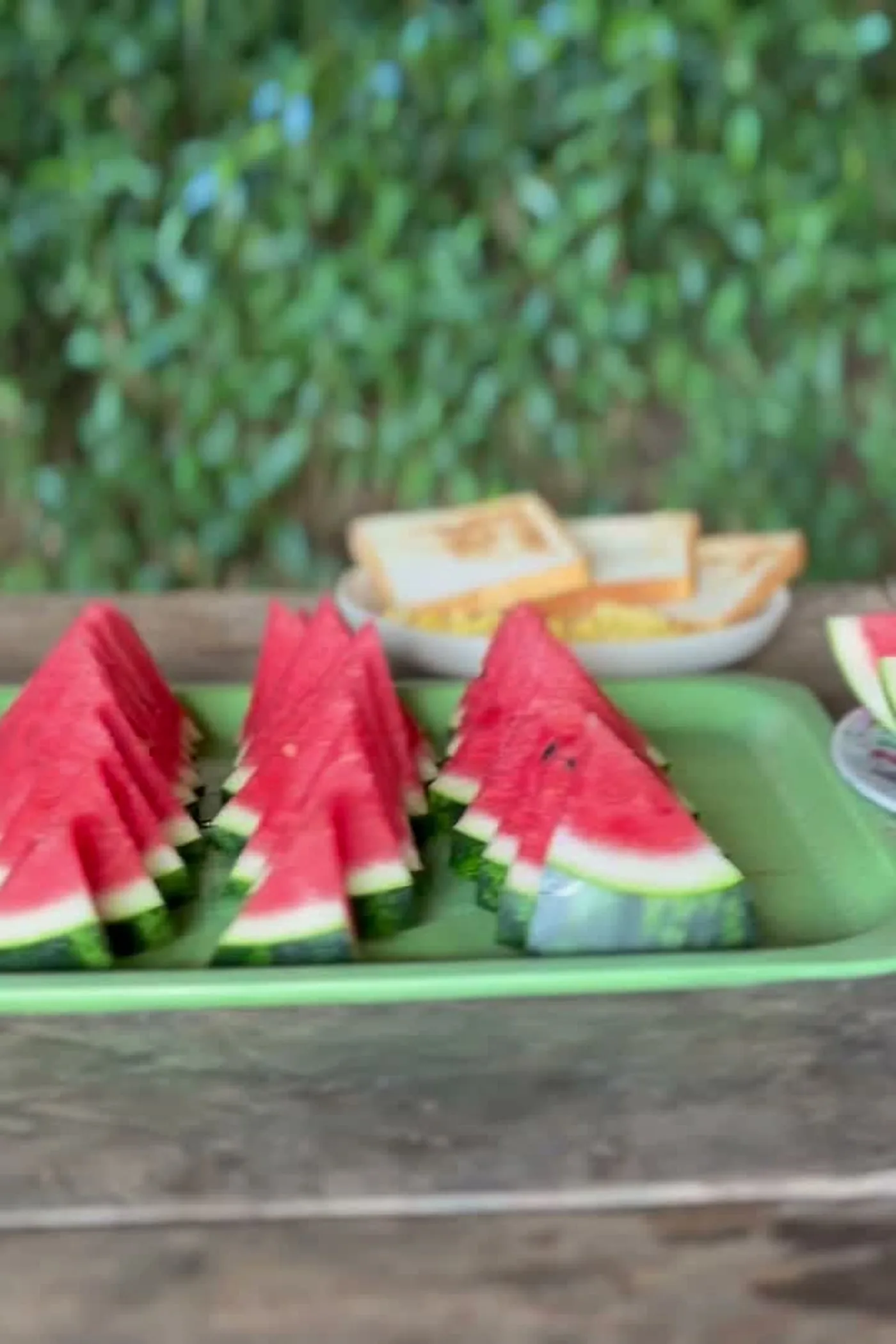 Toast, scrambled eggs and fresh watermelon on a wooden village table