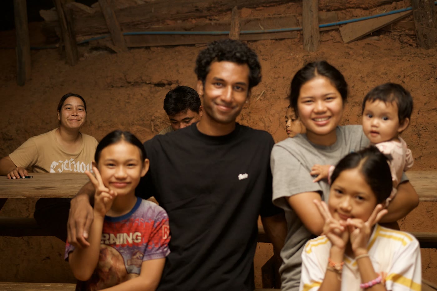 A guest posing with a village family